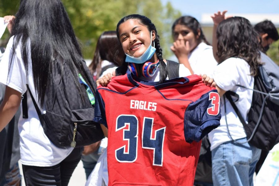 Senior Harmony Cardenas prepares to walk in a lunch sports parade for those playing in Powderpuff, an end of the year flag football game where girls play flag football, while boys cheer them on.