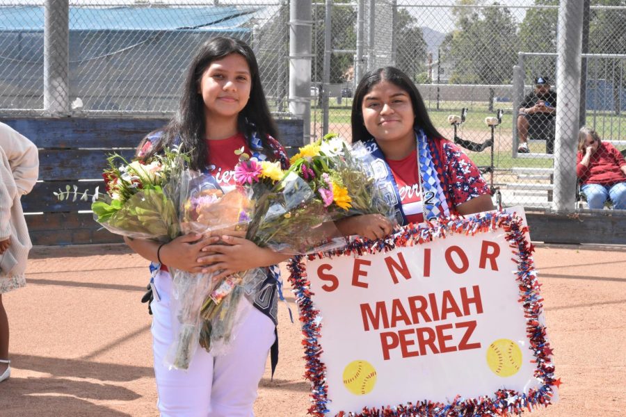 Seniors Andrea Gonzalez and Mariah Perez pose for a photo on the field for their softball senior night.