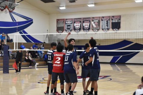 Before the boy’s volleyball team returns to the court, they gather around and say their chant, “Fight on me, fight on three, one, two, three, fight!