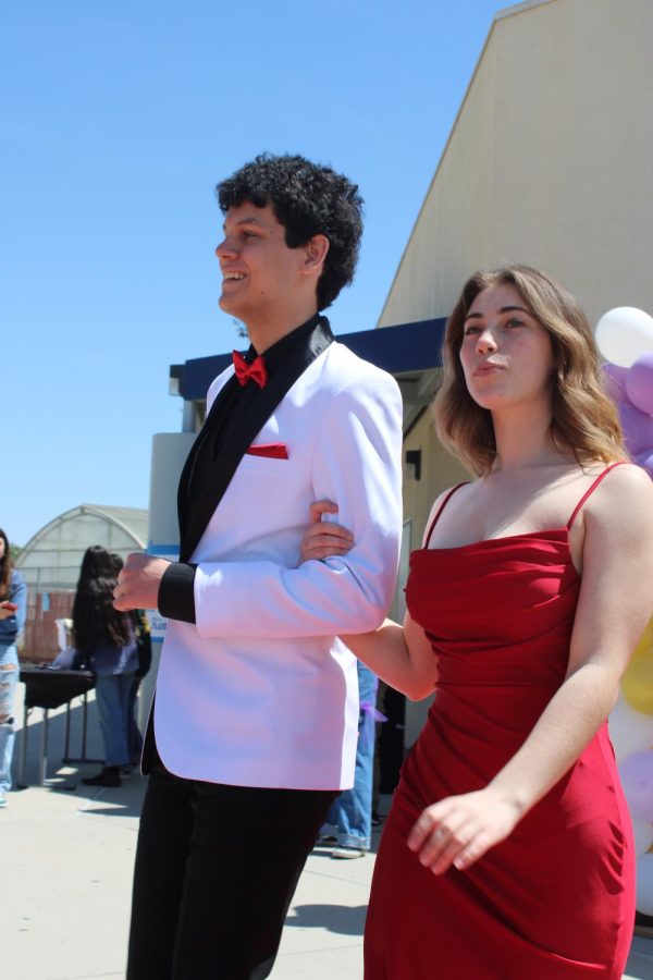 Matching with the red carpet, Junior Ethan Werk and Senior Roshelle Easton walk down the runway dressed in red or in red accents. 