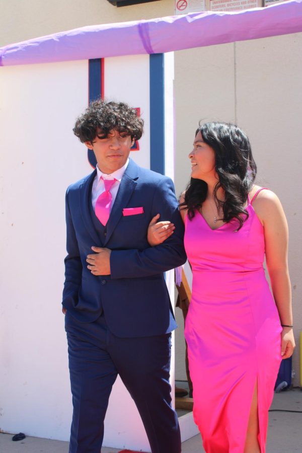 Hand in hand, juniors Alexander Valterria and Leyla Cossio escort each other down the red carpet dressed in a motif of fucshia.  