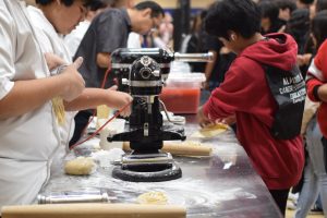 8th graders from middle schools around the district came for the CTE showcase. Culinary is showing students how to make pasta noodles!