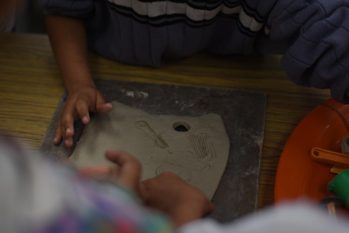 Students of La Sierra High Schools ceramics class teach Collett visitors how to handle clay. 
